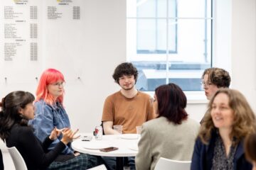 Group of students around a table in a seminar room